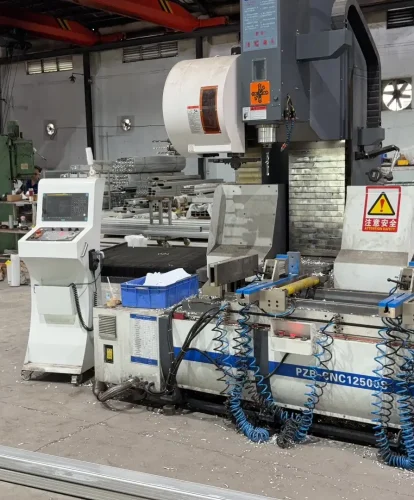 Worker operating an advanced CNC machine to process heavy-duty aluminum tent profiles.