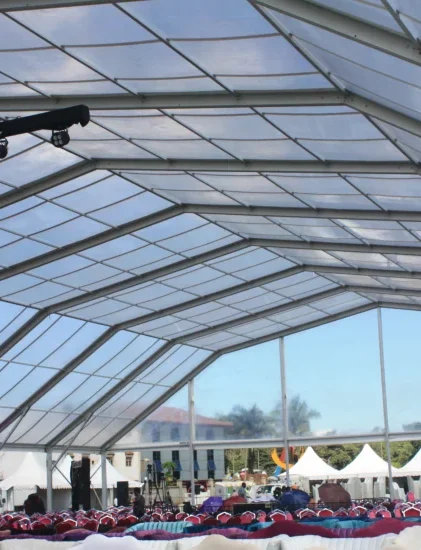 Clear top polygonal clear span tent interior prepared for a large-scale event.
