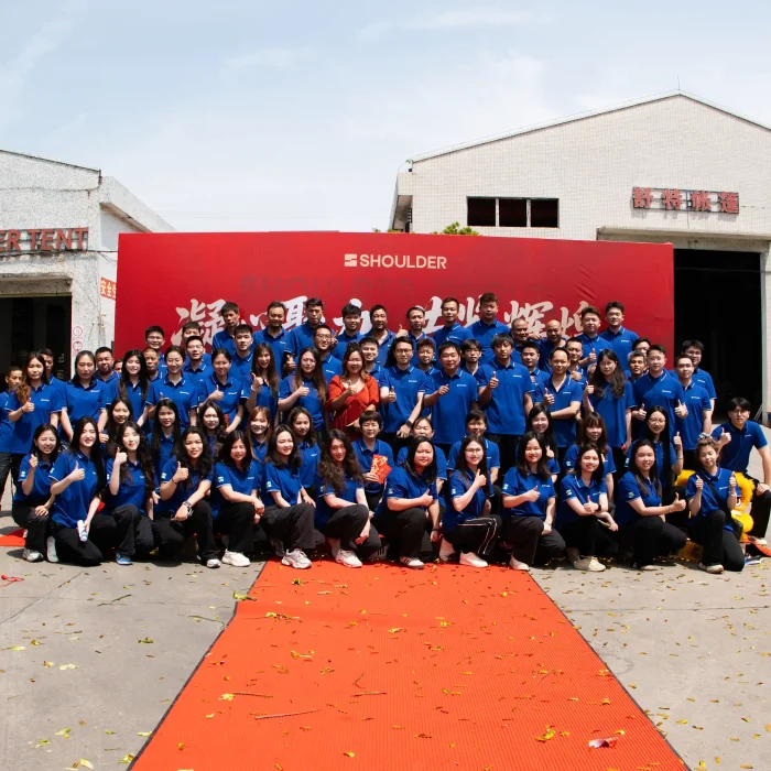 Large group photo of the entire Shoulder Tent workforce outside the new manufacturing plant.