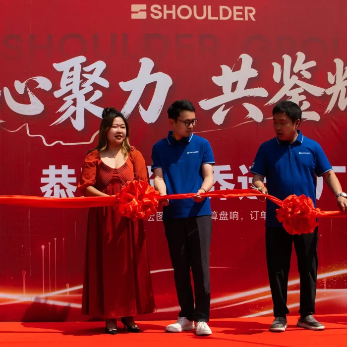 Company executives cutting the red ribbon to officially open the new clear span tent factory.