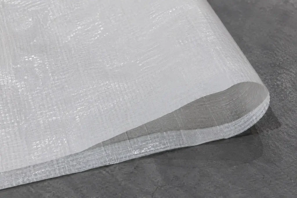 Detailed texture of folded white waterproof fabric for aluminum tents.