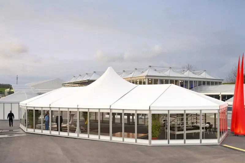 Interior of a massive clear span aluminum structure with tiered arena seating.