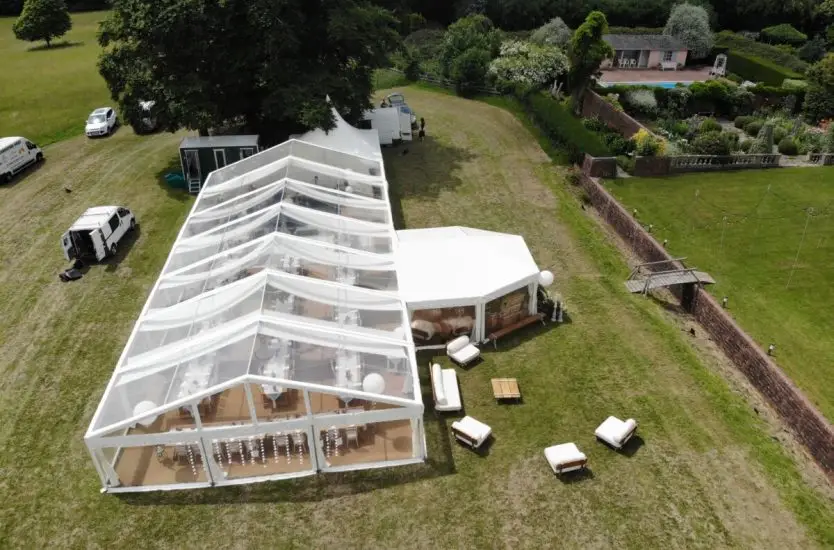 Massive white curved roof aluminum clear span dome on an asphalt yard.
