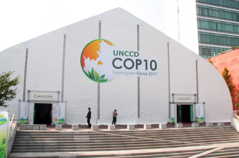 Exterior of a massive white aluminum clear span tent hosting an international summit event.