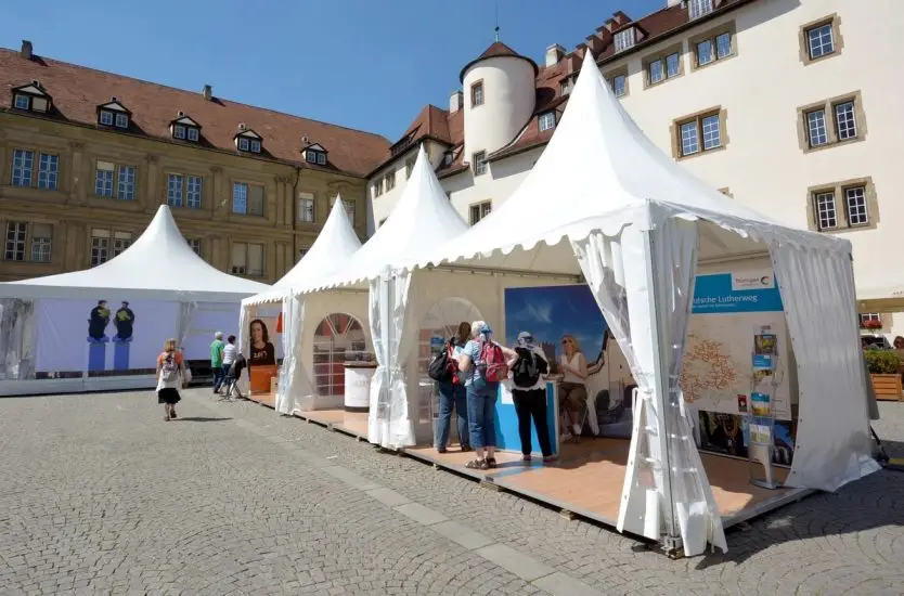 Aluminum frame pagoda tents used as exhibition booths in a paved public square