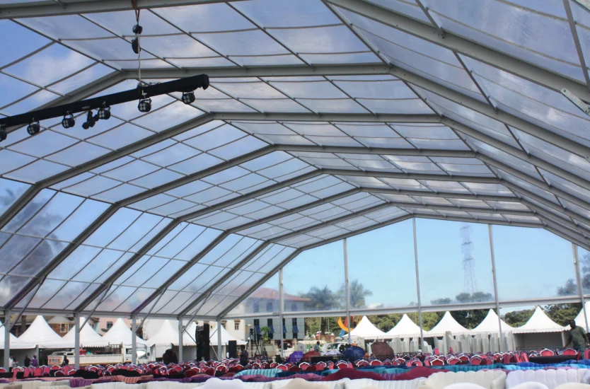 Clear roof polygonal tent interior showing aluminum framework and event seating.