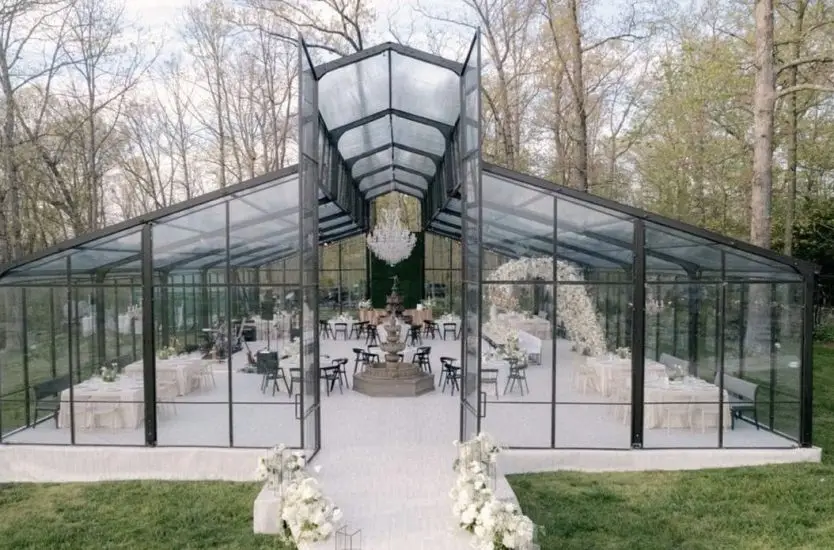 Elegant black aluminum clear span tent featuring a high central peak and a transparent structure.