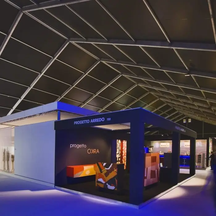 Interior of an aluminum clear span exhibition tent featuring custom trade show booths.
