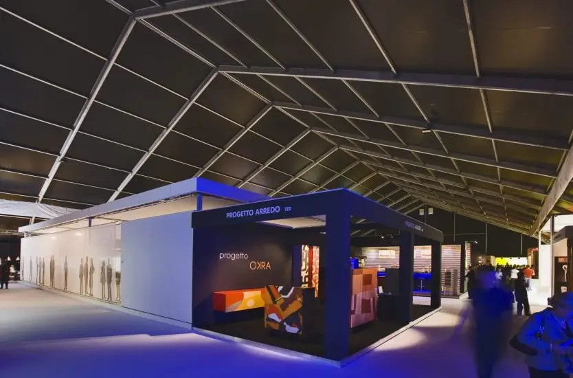 Interior of an aluminum clear span exhibition tent featuring custom trade show booths.